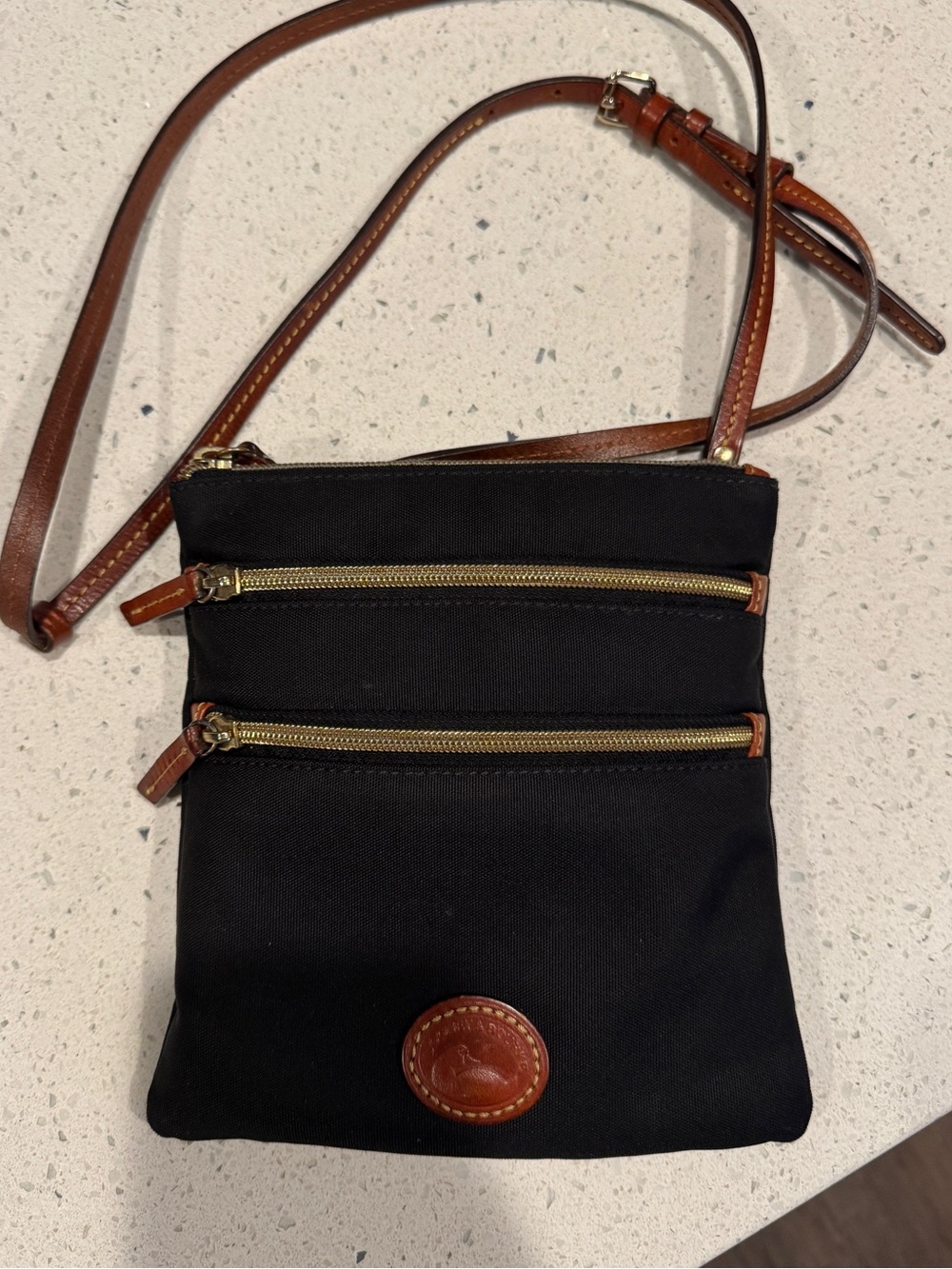 Dooney & Bourke Black Crossbody with Brown Leather Trim and Gold Zippers